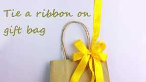 Tie a ribbon on gift bag🛍️
